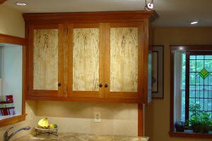 Wooden kitchen cabinets with marble countertop.
