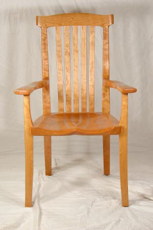 Wooden chair with vertical slat back.