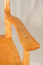 Wooden chair armrest with smooth finish.