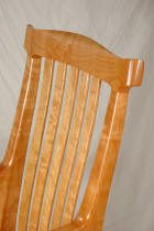 Wooden chair back with vertical slats.