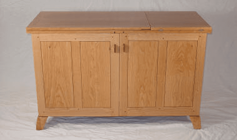 Wooden cabinet with two doors and handles.