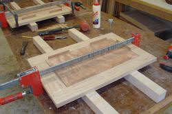 Woodworking project with clamps and tools.