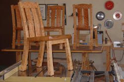 Wooden chairs in a workshop setting.