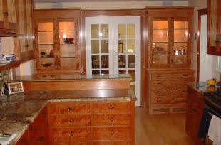 Wooden kitchen with glass cabinet doors.