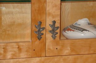 Wooden cabinet with decorative metal handles.
