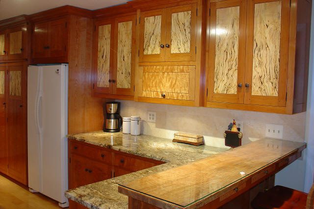 Wooden kitchen cabinets with granite countertops.