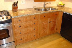Wooden kitchen cabinets with granite countertop.