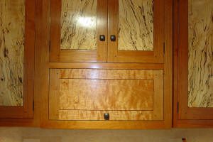 Wooden cabinet with patterned door panels.