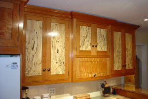 Wooden kitchen cabinets with decorative paneling.